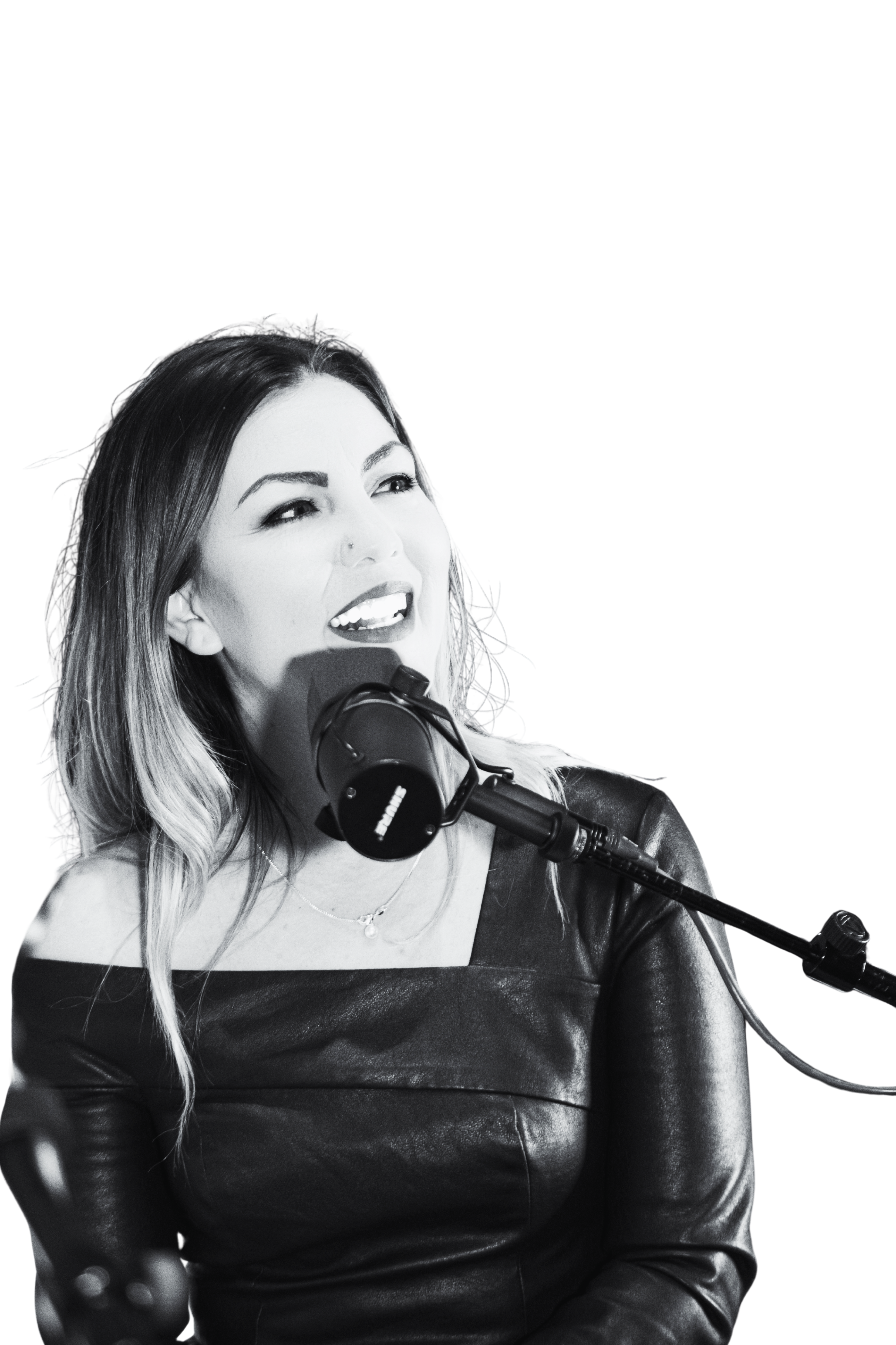 Dr. Julia Garcia speaking into a podcast microphone